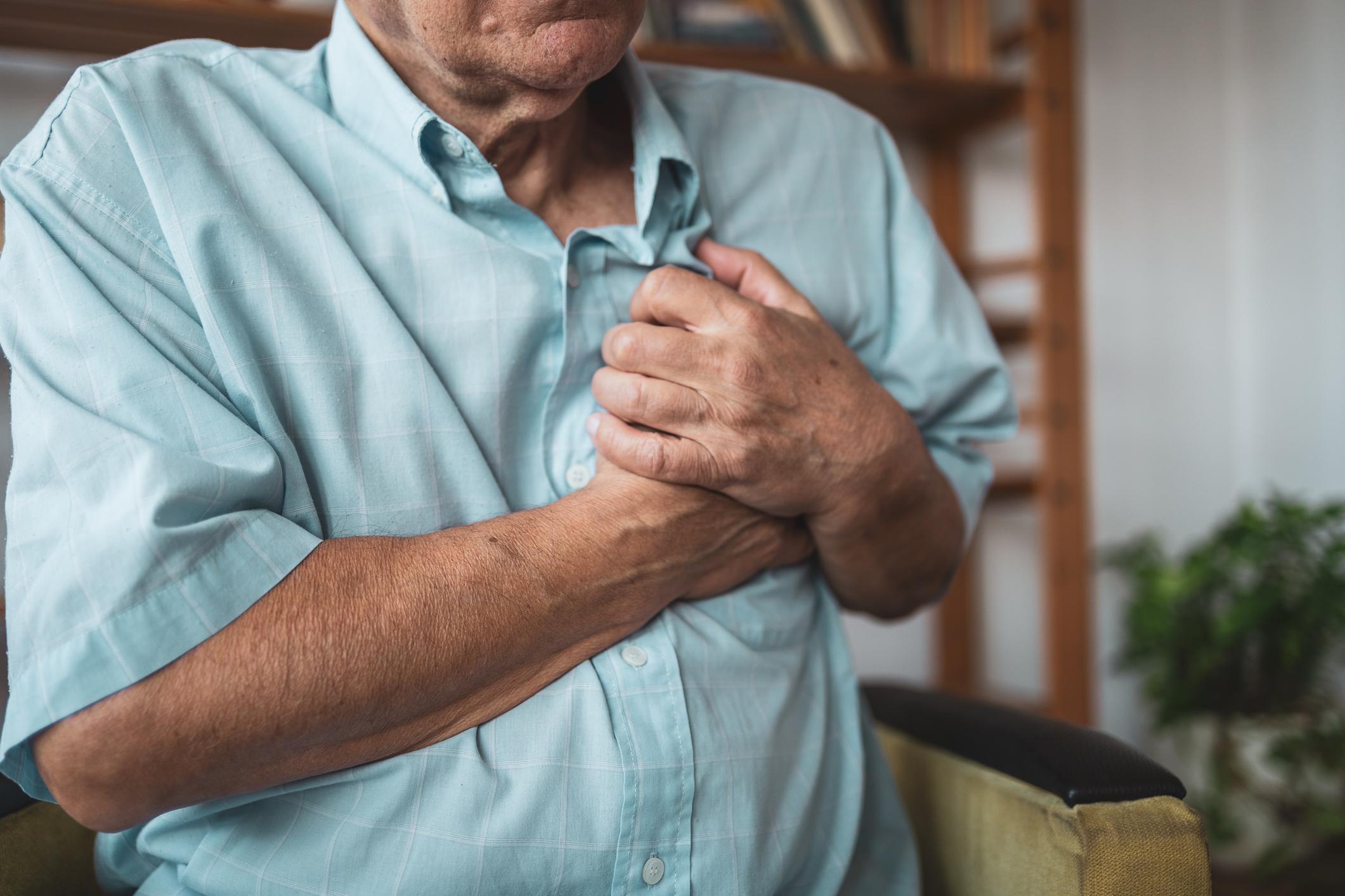 Man holding chest in pain