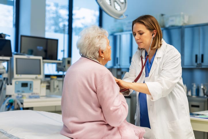 Photo shows doctors listening to woman's heart