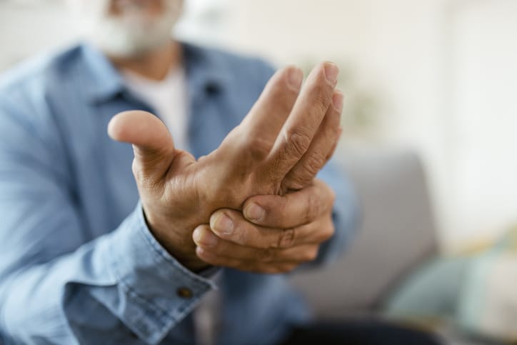 Photo shows man with hand pain