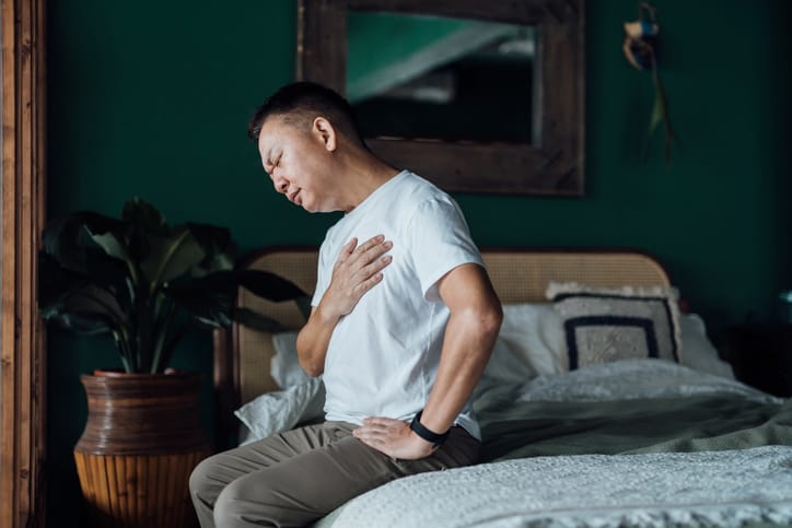 Photo shows man holding chest