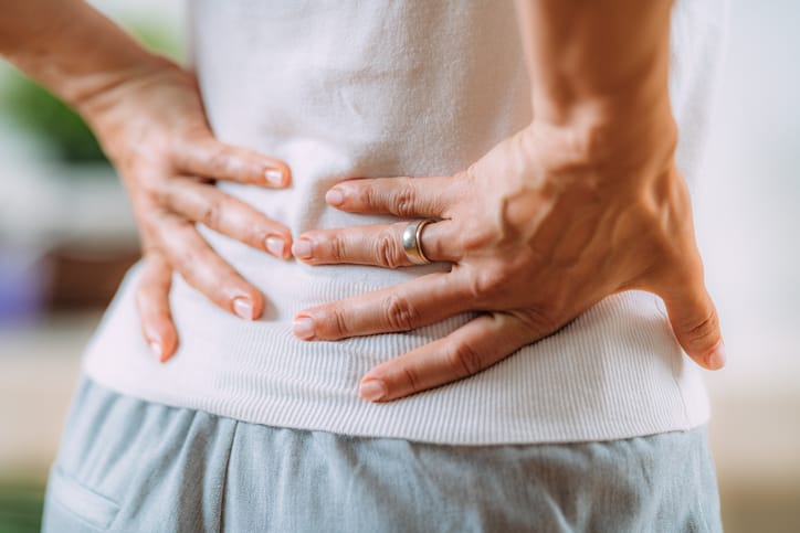 Photo shows a woman having sciatic nerve pain in her lower back/Getty Images