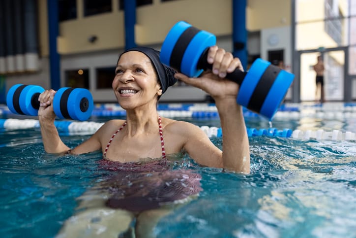 Photo shows woman with weights in a pool
