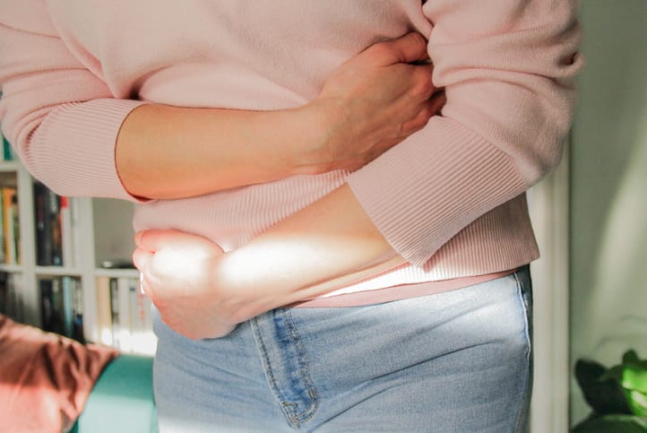 Photo shows woman with a belly ache