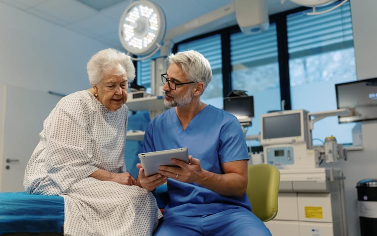 Elderly patient speaking with her doctor in an exam room