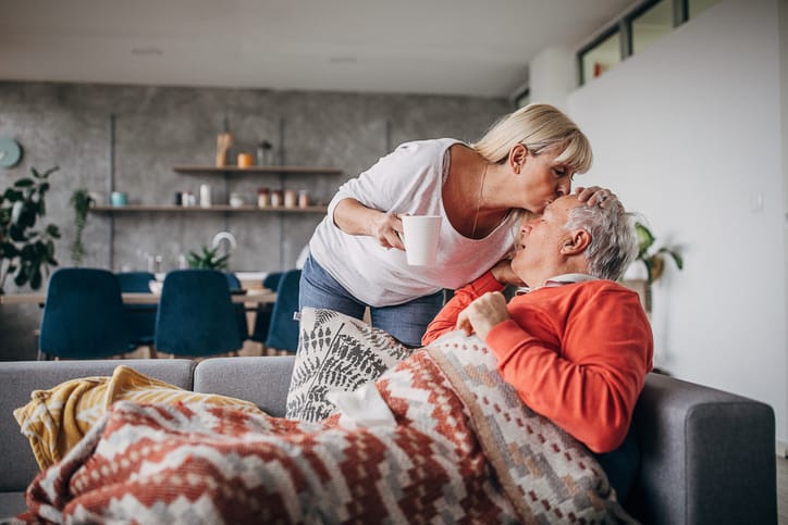 Photo shows woman kissing her husband