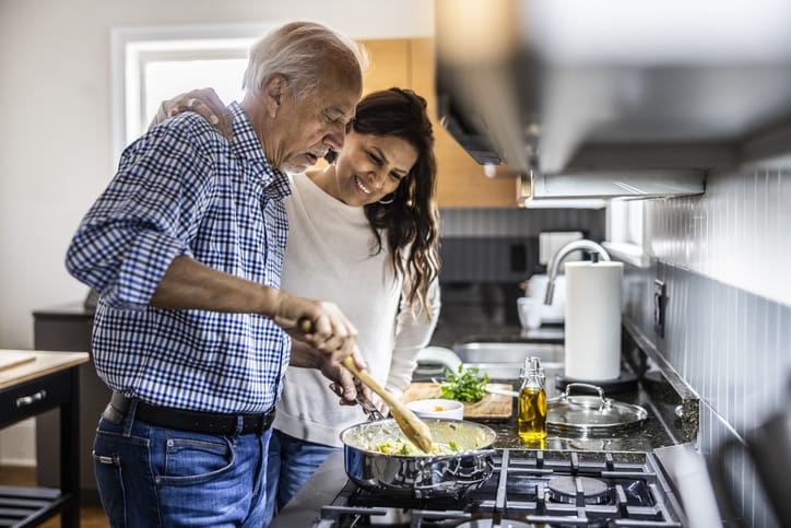 Photo shows older couple cooking