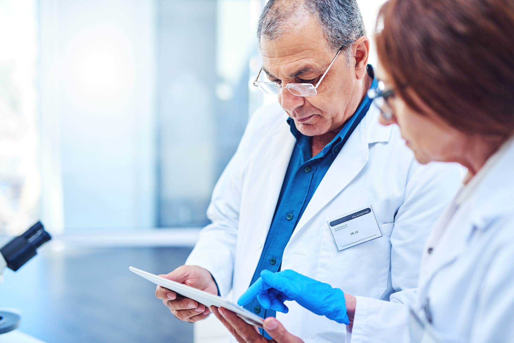 Shot of two mature scientists using a digital tablet in a laboratory