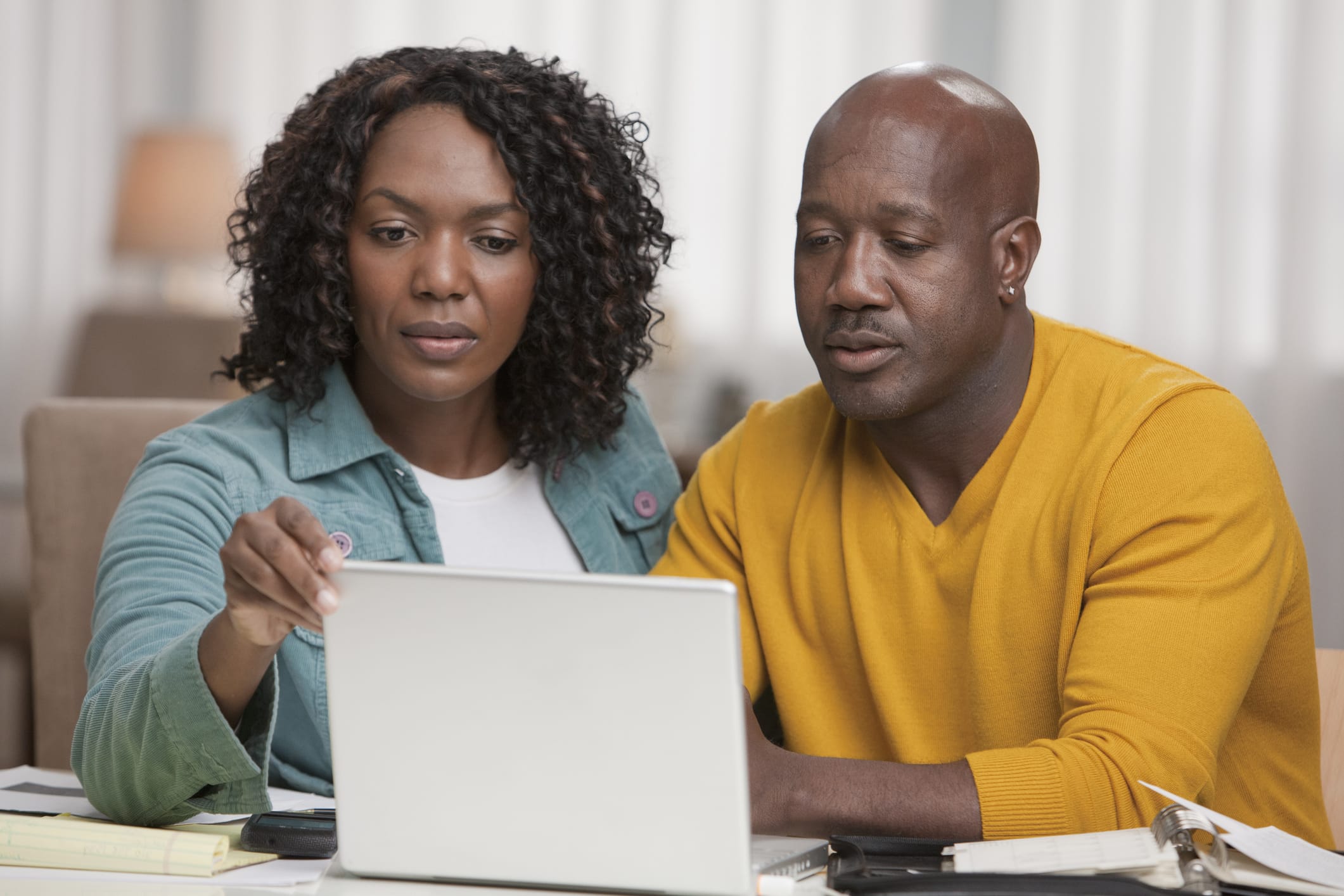 Couple taking a survey together on laptop