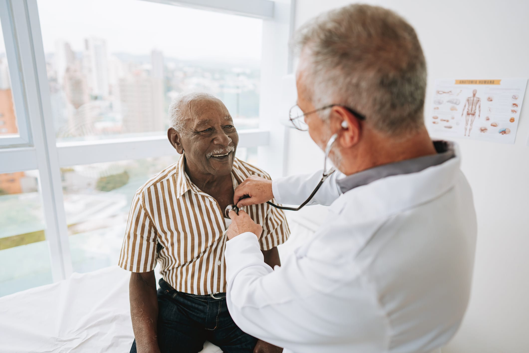 Doctor listening to an African American patient's heartbeat