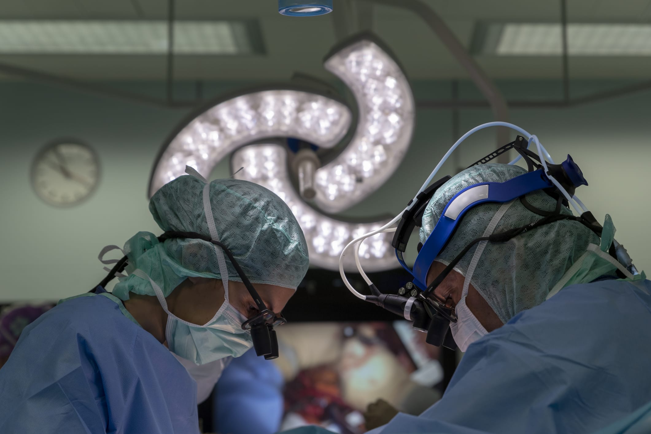 two cardiac surgeons operating on a patient