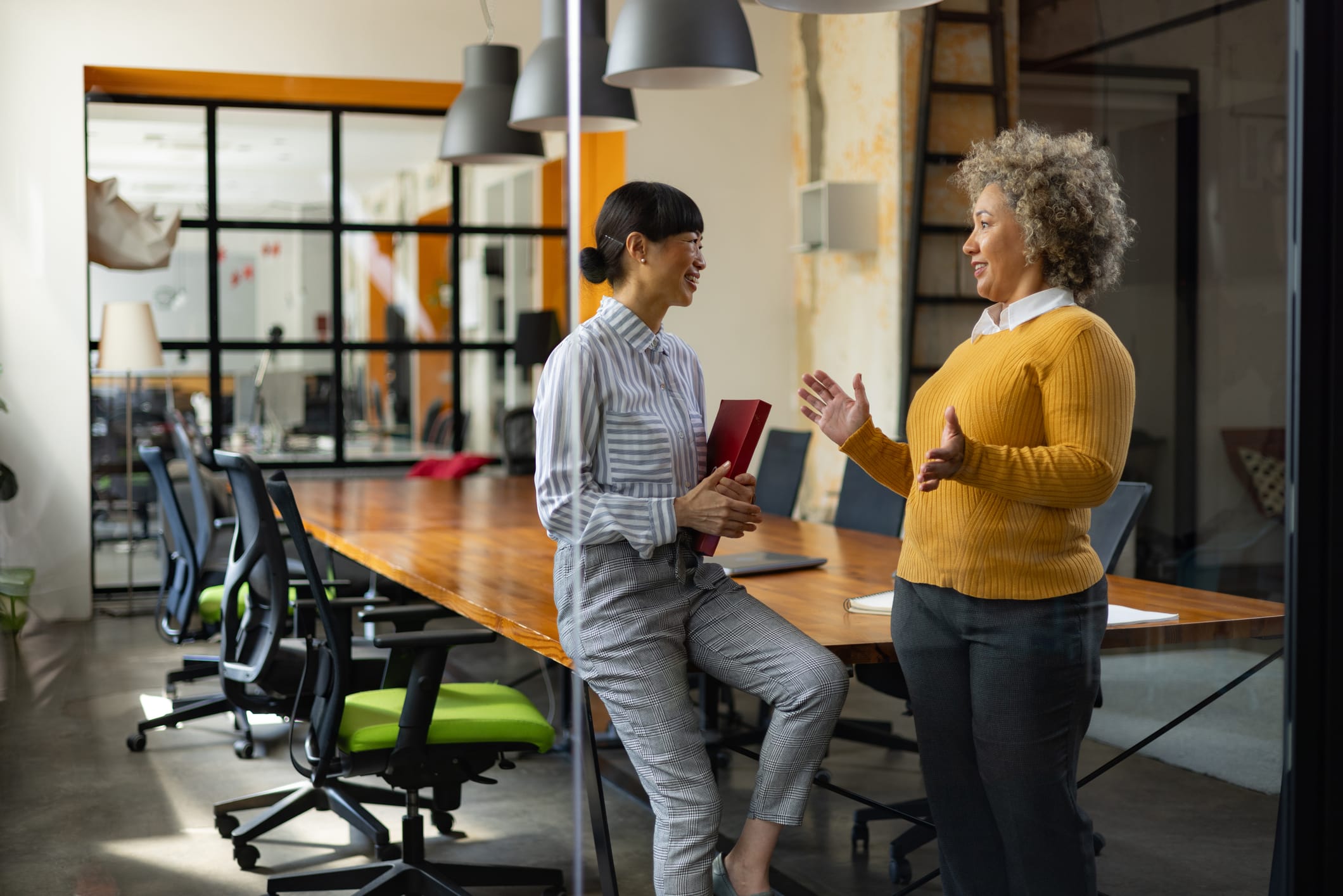 Businesswomen communicating while working in the office