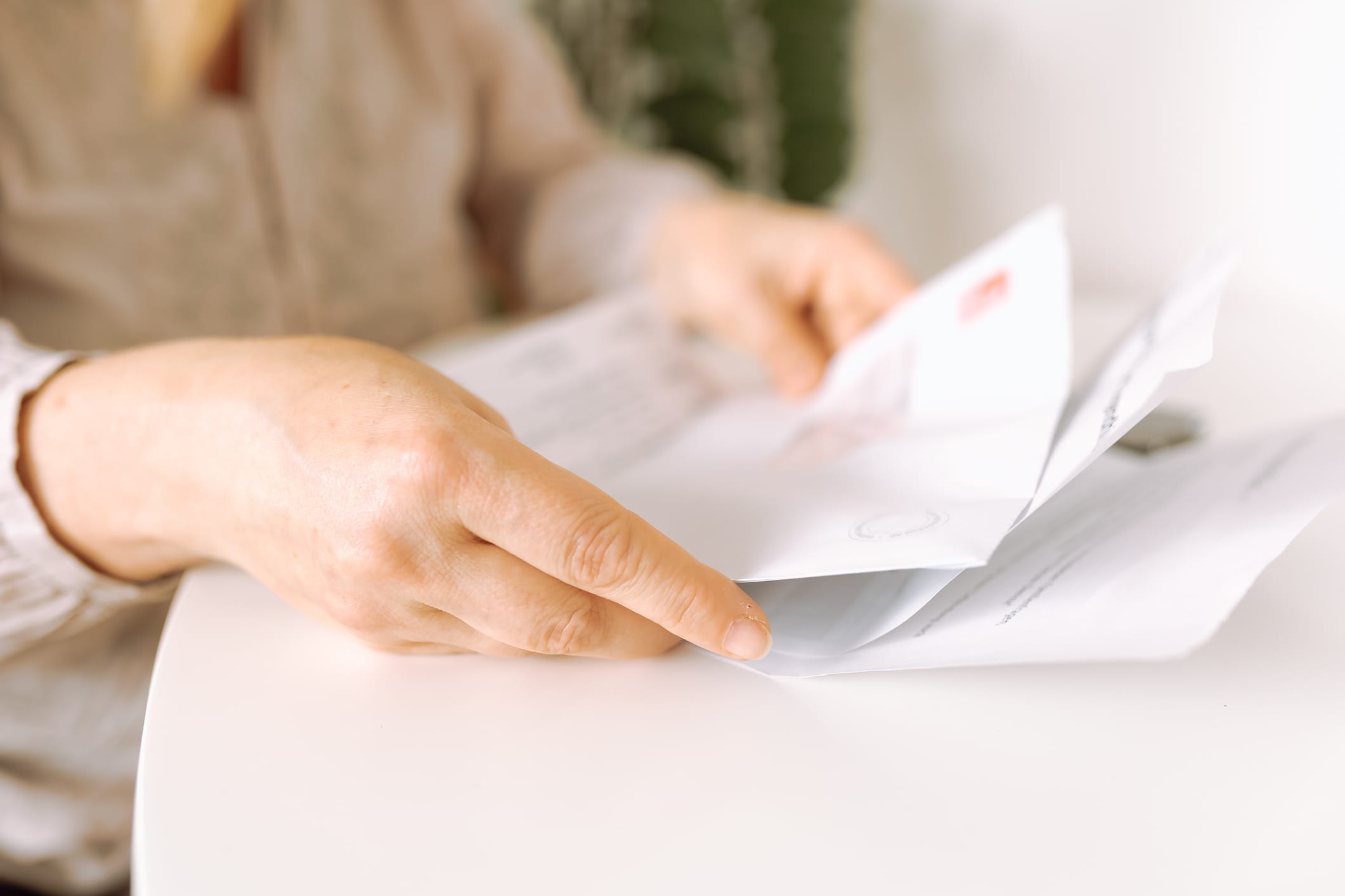 woman's hands holding an envelope with a letter