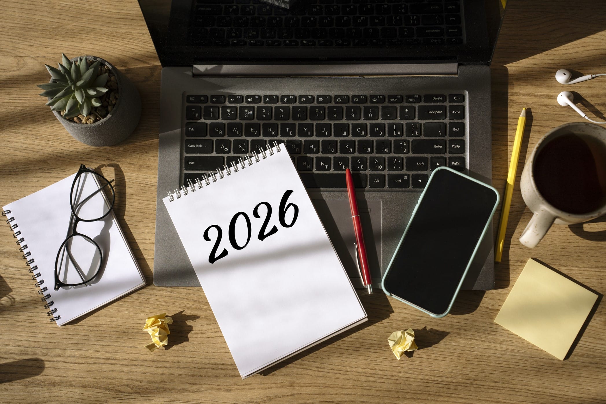 A 2026 planner on a desk with laptop and writing tools
