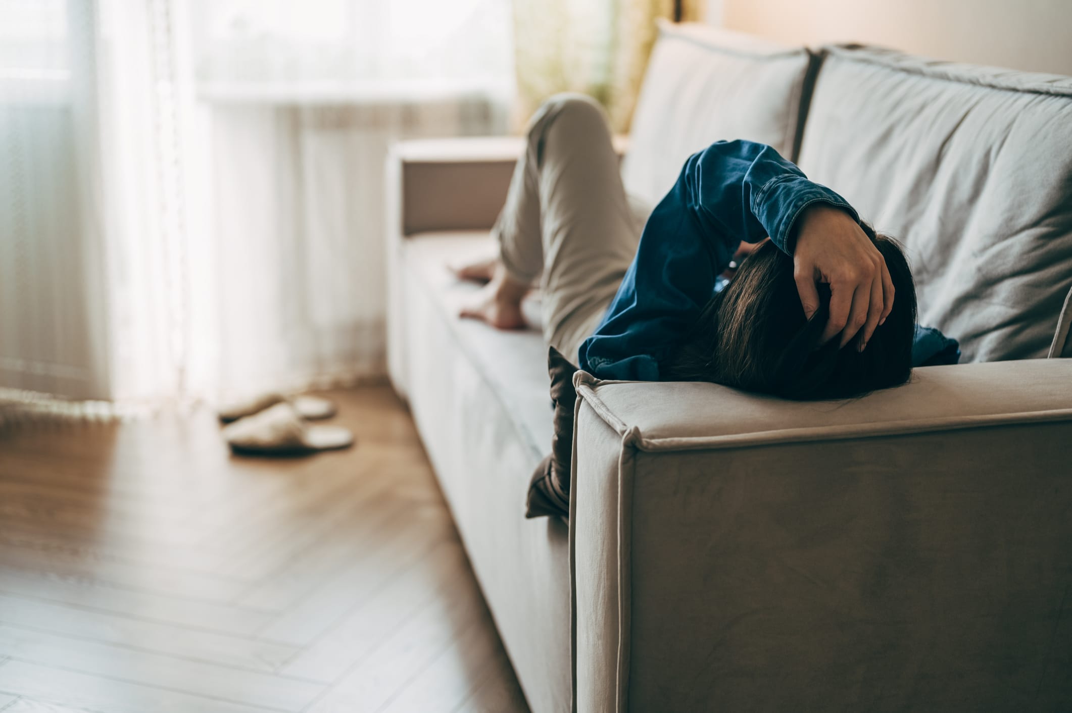 Tired woman resting on couch