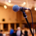 microphone on a stand before a blurred background